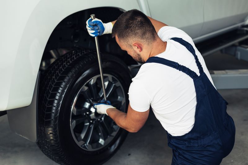 high-angle-male-mechanic-changing-car-wheels-1.jpg